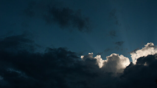 Black and white cumulus clouds on evening sky web banner.