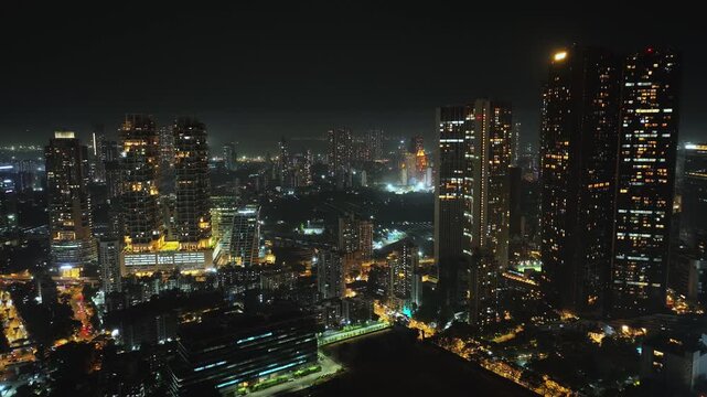 A stunning aerial night view of Mumbai&rsquo;s high-rise buildings, glowing with city lights and showcasing the vibrant energy of India&rsquo;s financial capital. The illuminated skyscrapers and skyline of Mumbai
