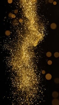 Golden glitter bokeh sparkles on solid black background.