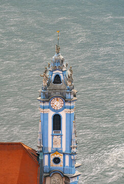 Parish and Collegiate Church of the Assumption of Mary in Durnstein by the Danube river showing historic architecture.