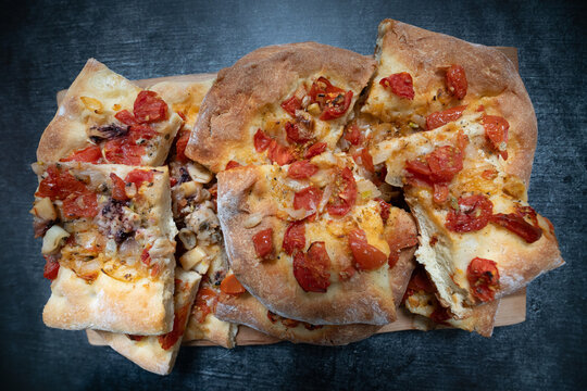 A fresh pizza has been cut into slices and photographed from above. The pizza is homemade.