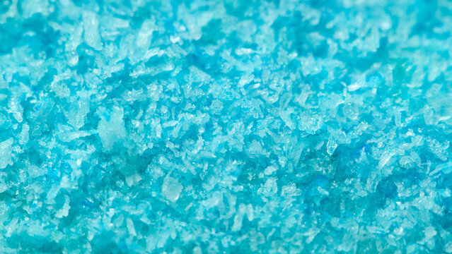Close view of blue granules on a flat surface during daytime in a well-lit space