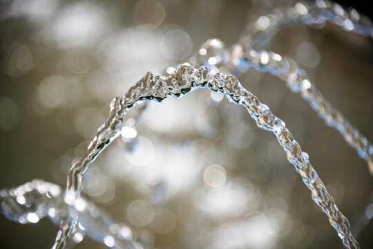 water splashing in a curve at a fountain in a park in lower Austria in close up