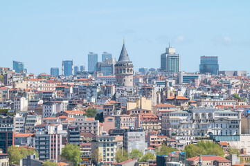 Naklejka premium view of a urban zone with the galata tower in the center and partial clear sky in the city of istanul, turkiye