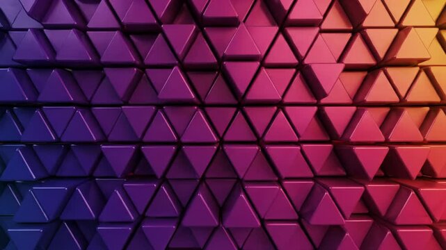A vibrant, dynamic abstract video of glossy, tessellated triangular shapes with a horizontal blue to yellow gradient and sweeping light reflections, creating a mesmerizing spectacle. Concept of