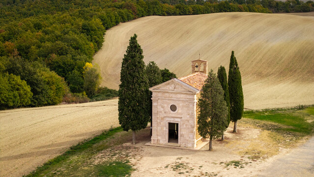 Madonna di Vitaleta Chapel in Tuscany Italy with iconic cypress trees on hills. Beautiful traditional Tuscan landscape in Val d Orcia countryside. Autumn rural travel scenic