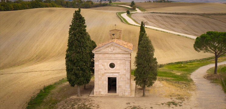 Italy Tuscany Vitaleta chapel aerial panoramic landscape Madonna di Vitaleta iconic little church with cypresses in Val d Orcia San Quirico. drone high angle countryside, rolling hills Pienza