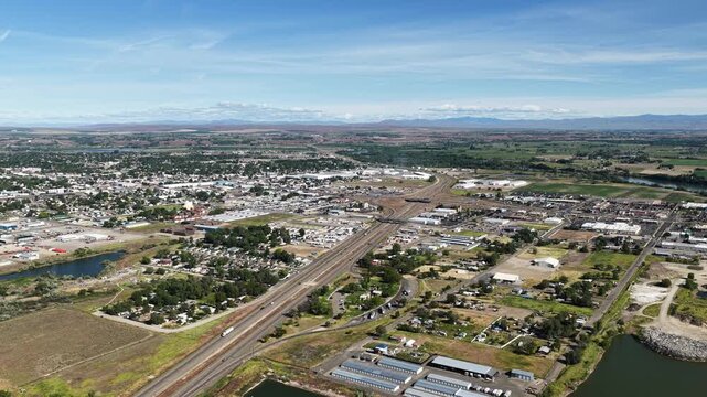 High wide aerial of rural town Ontario Oregon on Idaho border sunny spring day