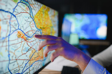 Logistics manager using digital map for freight dispatch planning © Serhii