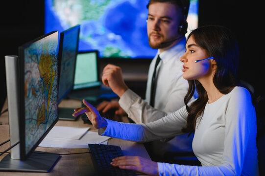 Dispatch center operators tracking freight logistics on computers