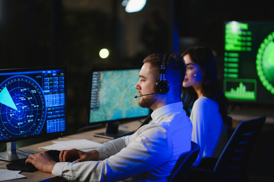 Air traffic controllers managing flights in control room