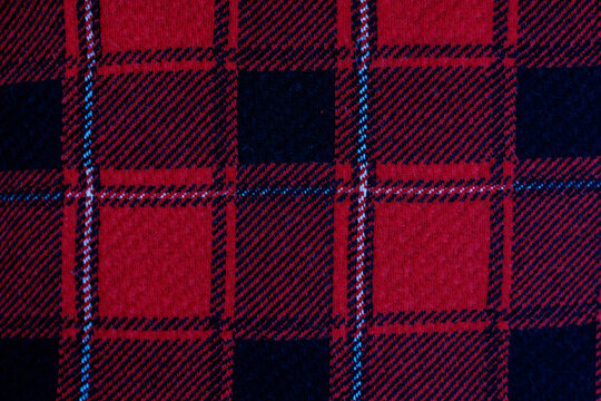 Red and black tartan plaid fabric texture background