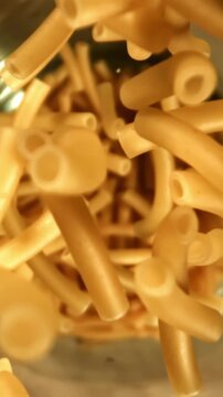 Super slow motion dry maccheroni pasta . Filmed on a high-speed camera at 1000 fps. High quality FullHD footage