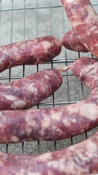 Close up of uncooked raw sausage showcasing its juicy texture, ideal for flavorful dishes and culinary creativity. black background. top view. High quality 4k footage