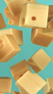 Pieces of maasdam cheese fly upwards on a blue background. Filmed on a high-speed camera at 1000 fps. High quality FullHD footage