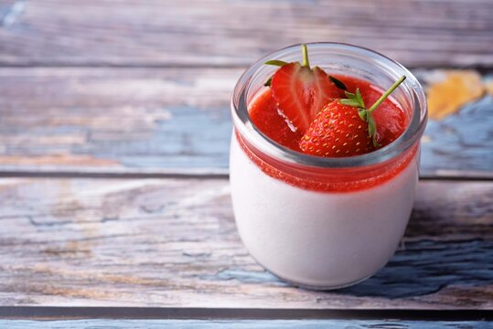 Strawberry panna cotta with strawberry sauce and fresh strawberries