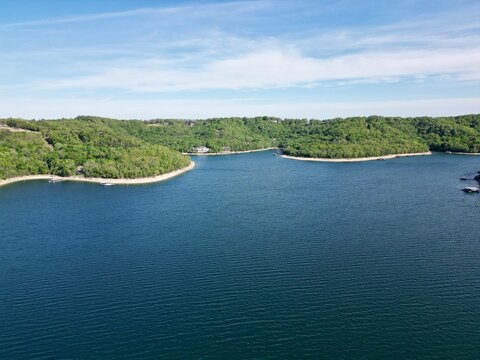 aerial view of forest covered hills above lake