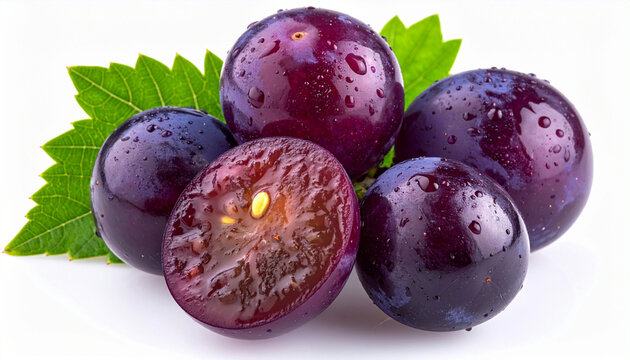 Fresh Japanese Kyoho grapes with water drops and a green leaf isolated on white background. Macro shot of sweet purple concord grape cut in half showing juicy pulp and seed, luxury fruit concept.