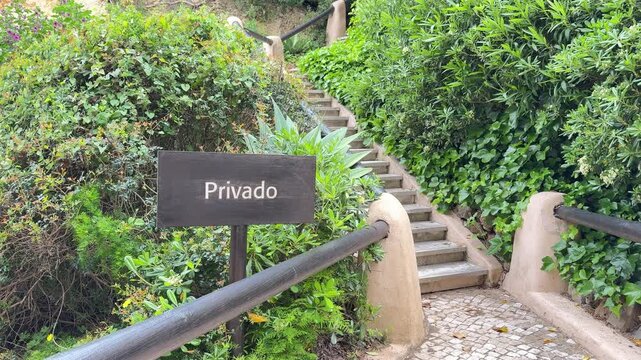 Privado sign by stairway through lush greenery, private access concept
