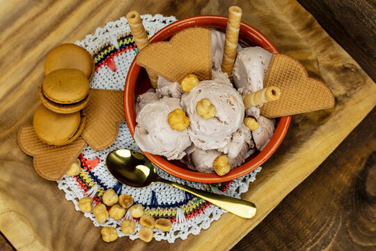 Vista dall'alto di ciotola con gelato alla nocciola , biscotti e wafer
