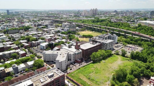 Aerial perspective of hoboken, new jersey, showing urban development, residential buildings, a baseball field, and the elevated nj transit hudson bergen light rail viaduct
