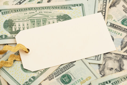 Blank price tag on twenty dollar bills for cost and pricing