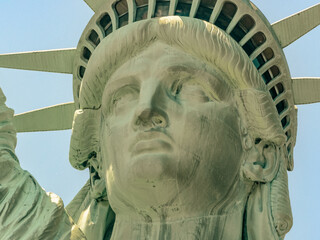 Close-Up of Statue of Liberty Face and Crown Against Blue Sky © Martin