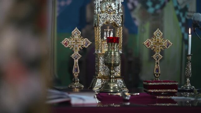 Golden altar setup with ornate crosses and chalice in a church setting