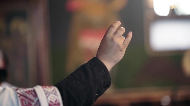 Priest Hand Raised for Blessing in Religious Ceremony, slow motion