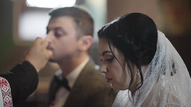 Bride and groom during the wedding ceremony held in a traditional church setting