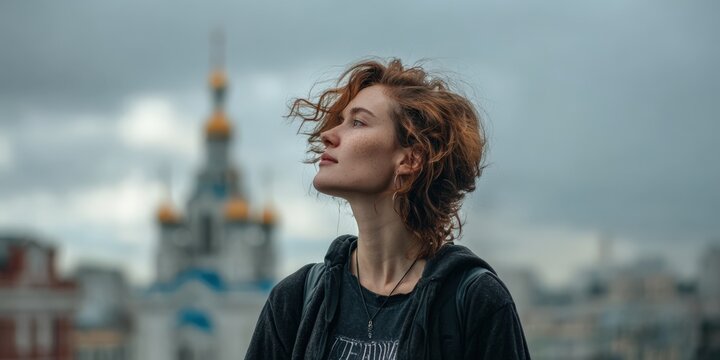 Gazing at the city skyline with a sense of wonder during an overcast day