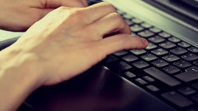 Business woman hands typing on a laptop keyboard. Online work, study, research, connection on pc. Closeup workspace with person fingers. Toned color