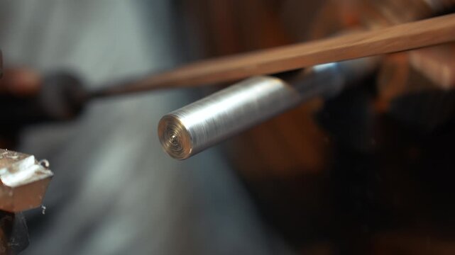 View of a metal rod being shaped and polished on a rotating lathe in a workshop in Kushtia, Khulna Division, Bangladesh.