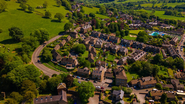 Aerial view of historical stone houses and countryside in Hathersage village