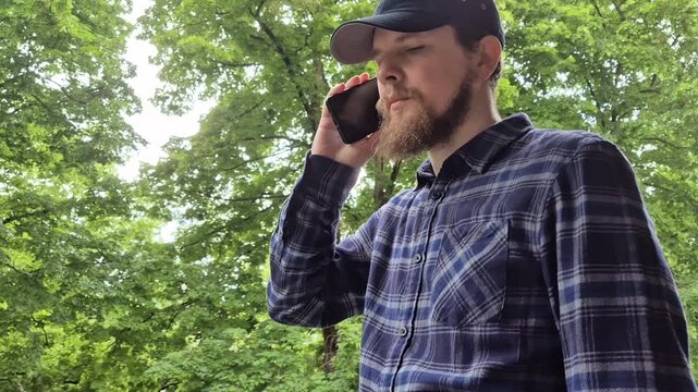 Man waiting for phone call answer outdoors natural communication lifestyle concept