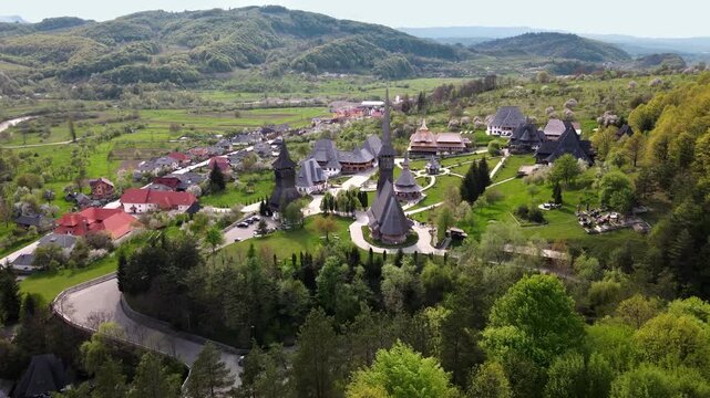 Aerial view of Barsana monastery complex nestled in lush green hills of Maramures region Romania.