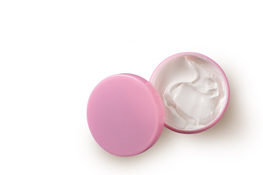 Top view of an open pink jar filled with creamy skincare product on white background. Concept of beauty, hydration, self-care, and daily skincare routine for healthy, smooth, and glowing skin.