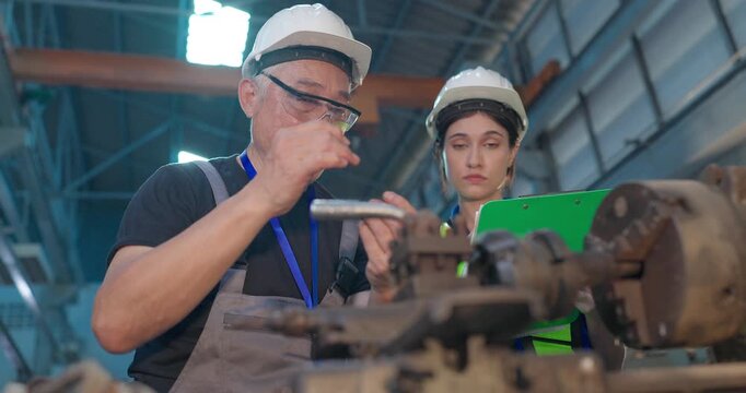 Father Shares Factory Know-How as Daughter Takes Notes in Family Business Transition