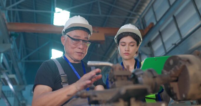 Father Shares Factory Know-How as Daughter Takes Notes in Family Business Transition