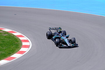 Obraz premium May 24, 2026, Montreal, Canada, Mercedes F1 car racing through Circuit Gilles Villeneuve corner. g.