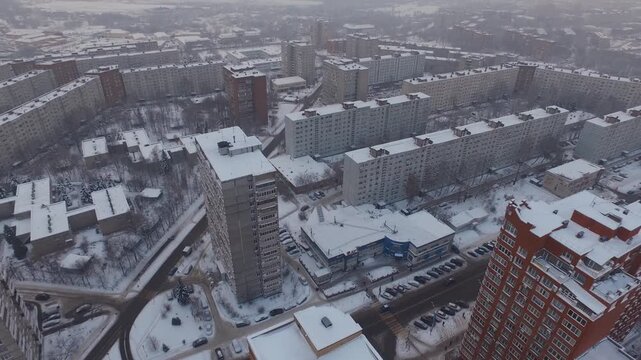 Aerial drone pullback over snowy Dzerzhinsky buildings