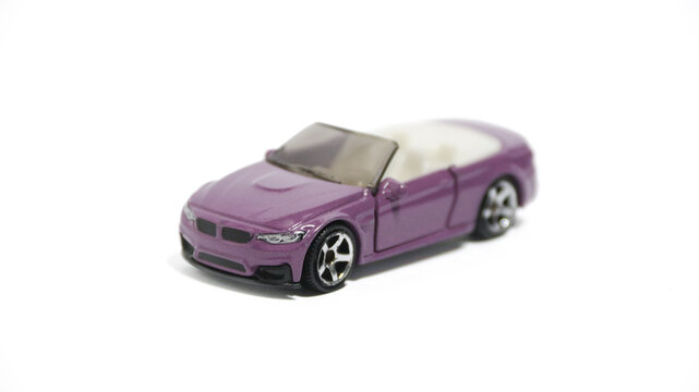 Matchbox Toy Car with Moving Parts 2020 BMW M4 Cabriolet in purple.
