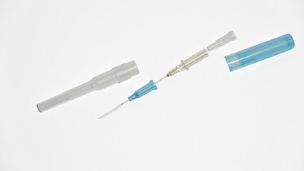 Fototapeta premium IV Catheter Cannula with Needle and Blue Cap Isolated on White Background.Standard sterile medical device used in hospitals and clinics for venous access and fluid administration.