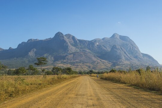 Dusty Road leading to the granite peaks of Mount Mulanje, Malawi