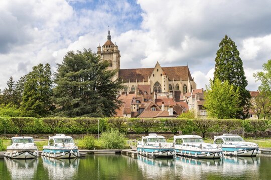 Harbour of Dole with houseboats of the rental company Nicols at the Rhine-Rhone-Canal, in the back the collegiate church Notre Dame, city of Dole, Burgundy-Franche-Comt&eacute;, France