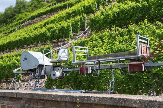 Mechanical vineyard machine in the middle of green vineyard slopes, monorack railway for overcoming extreme gradients in rough terrain, monorail rack railway, Calmont region, Moselle, Rhineland-Palatinate, Germany