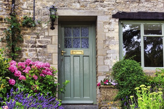 Decorated house entrance, front garden, famous village of Bibury in the Cotswolds, Gloucestershire, England, United Kingdom
