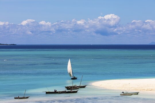 Fishing boats in turquoise green water on the beach of Kendwa, Zanzibar, Tanzania