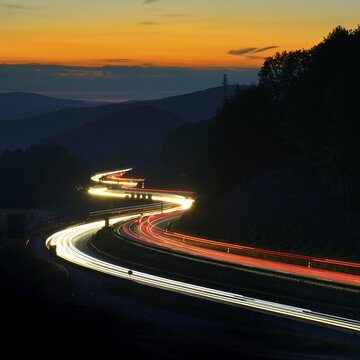 A3 motorway meanders through low mountain range landscape, light tracks at dusk, Spessart, Bavaria, Germany