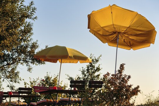 Two yellow parasols on a terrace, sunny weather, wind, symbol photo, Usedom, Germany